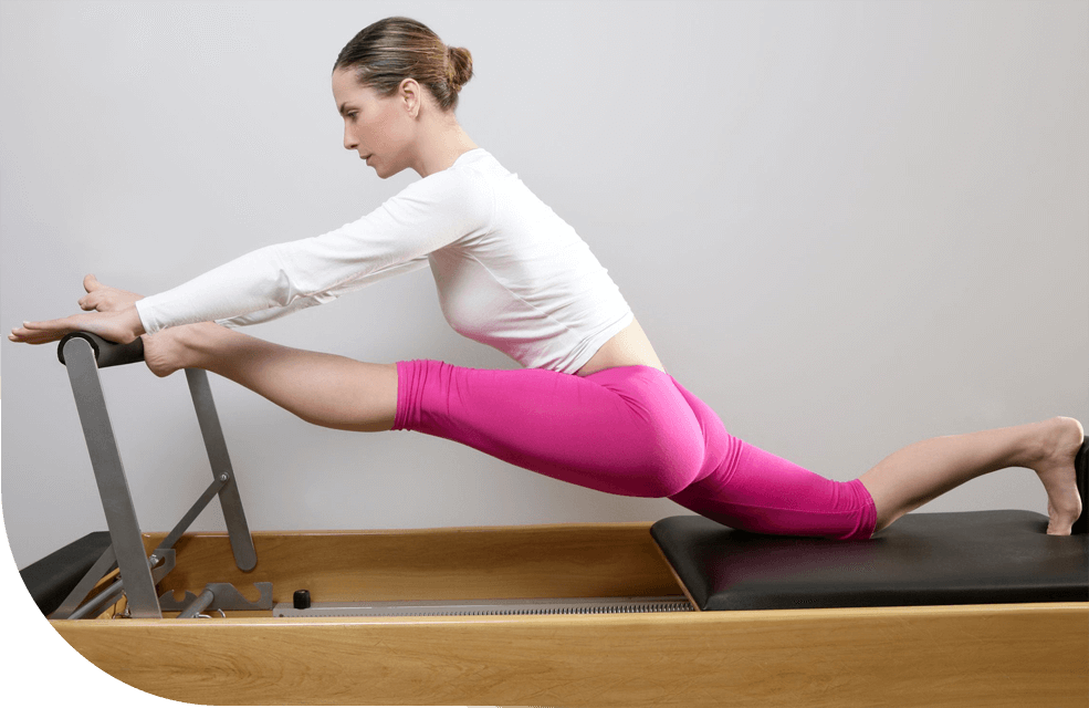 Woman Doing Pilates Stretching in Reformer Bed