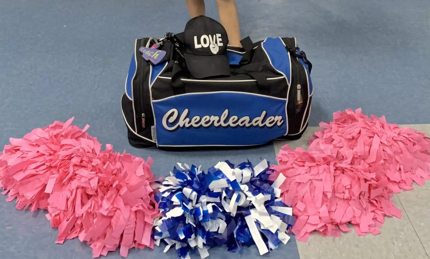 A blue color cheerleader bag with a cap