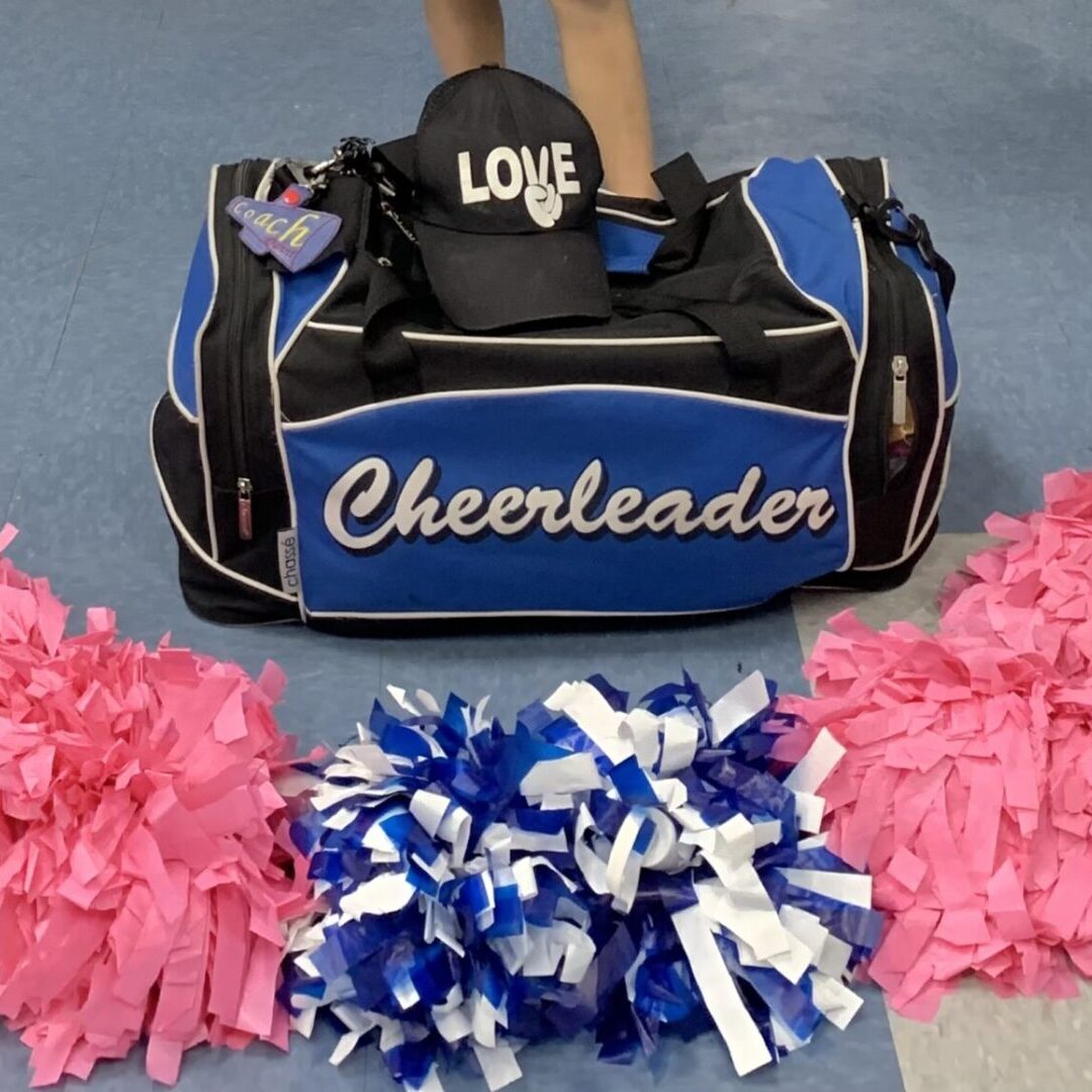 A blue color cheerleader bag with a cap